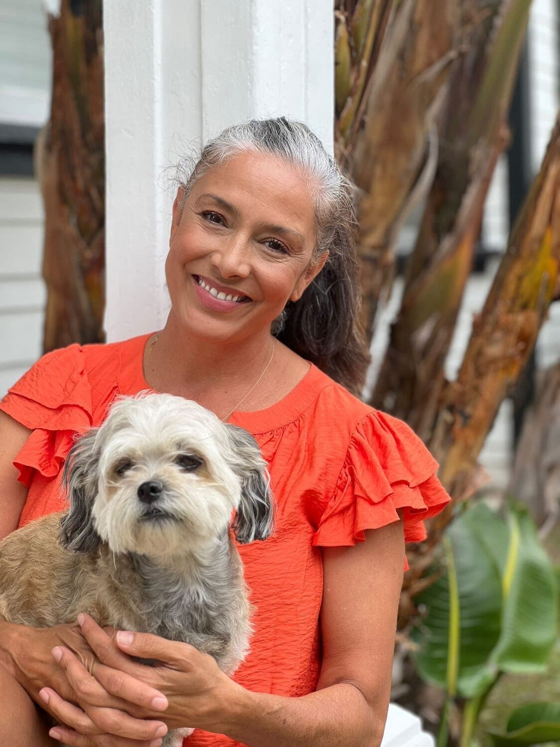 Kitty Martone smiling, holding her small dog